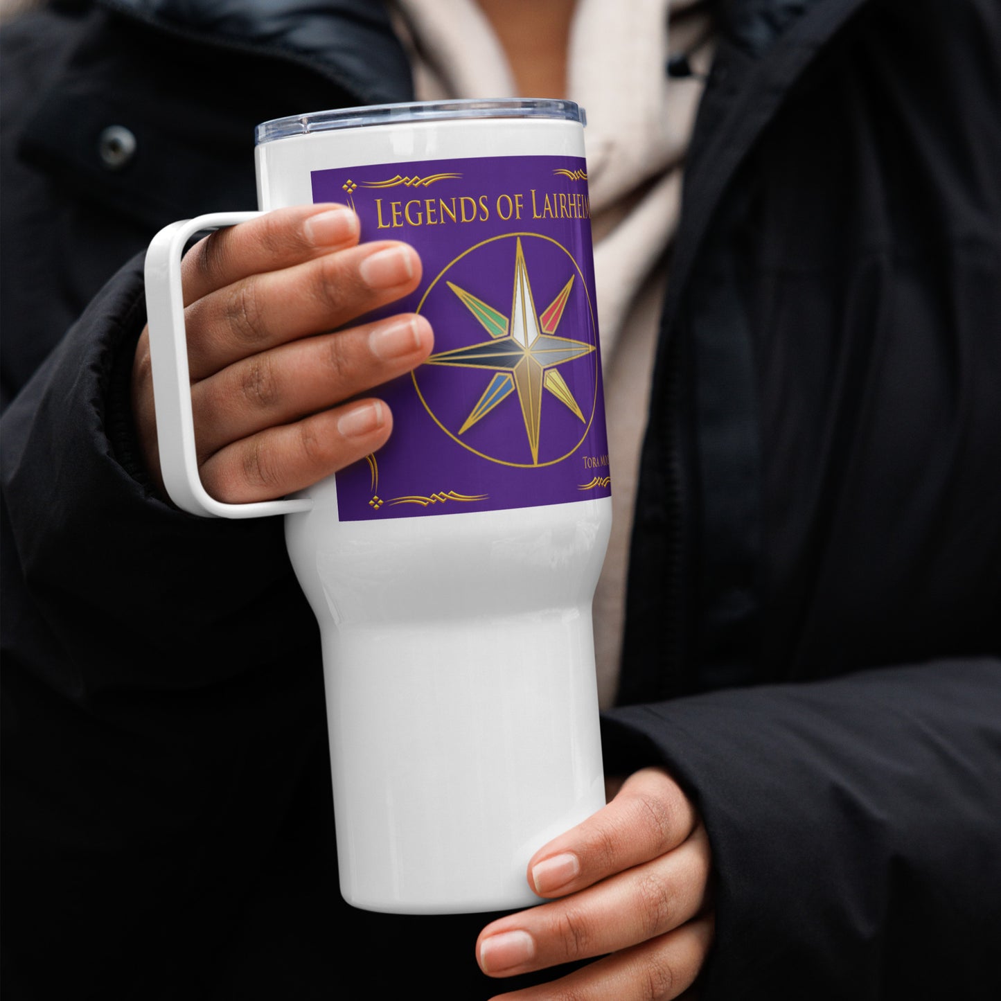 woman holding Legends of Lairheim Elemental Star travel mug
