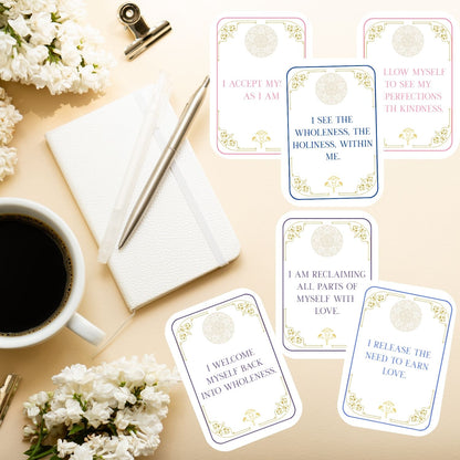 Isis Sacred Love affirmation cards displayed on a desk with journal and coffee, showing printable daily affirmations for self-love, acceptance, and embodied wholeness