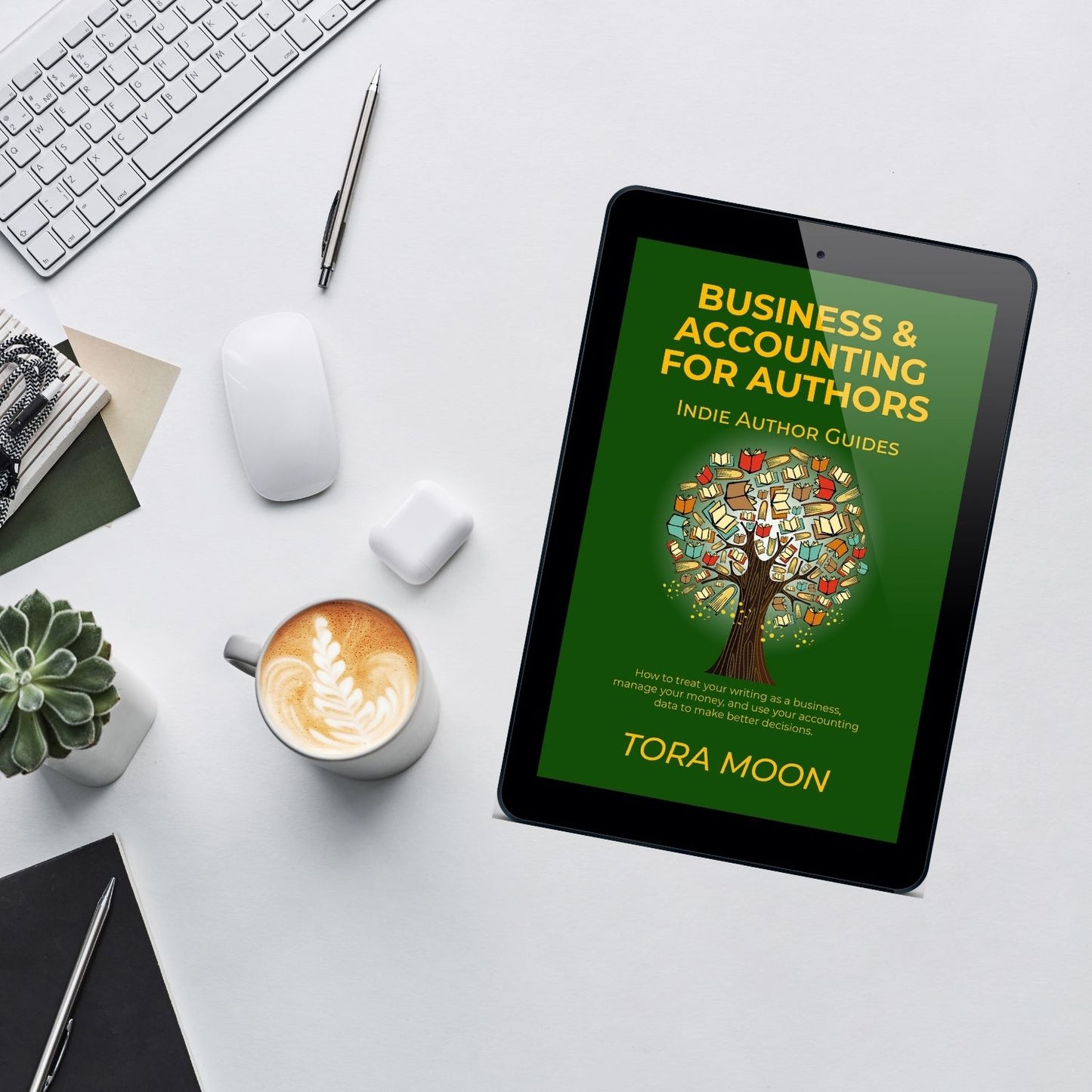 Business & Accounting for Authors ebook displayed on a tablet beside a latte, succulent, and laptop — a clean creative workspace for indie authors learning money management and accounting basics.