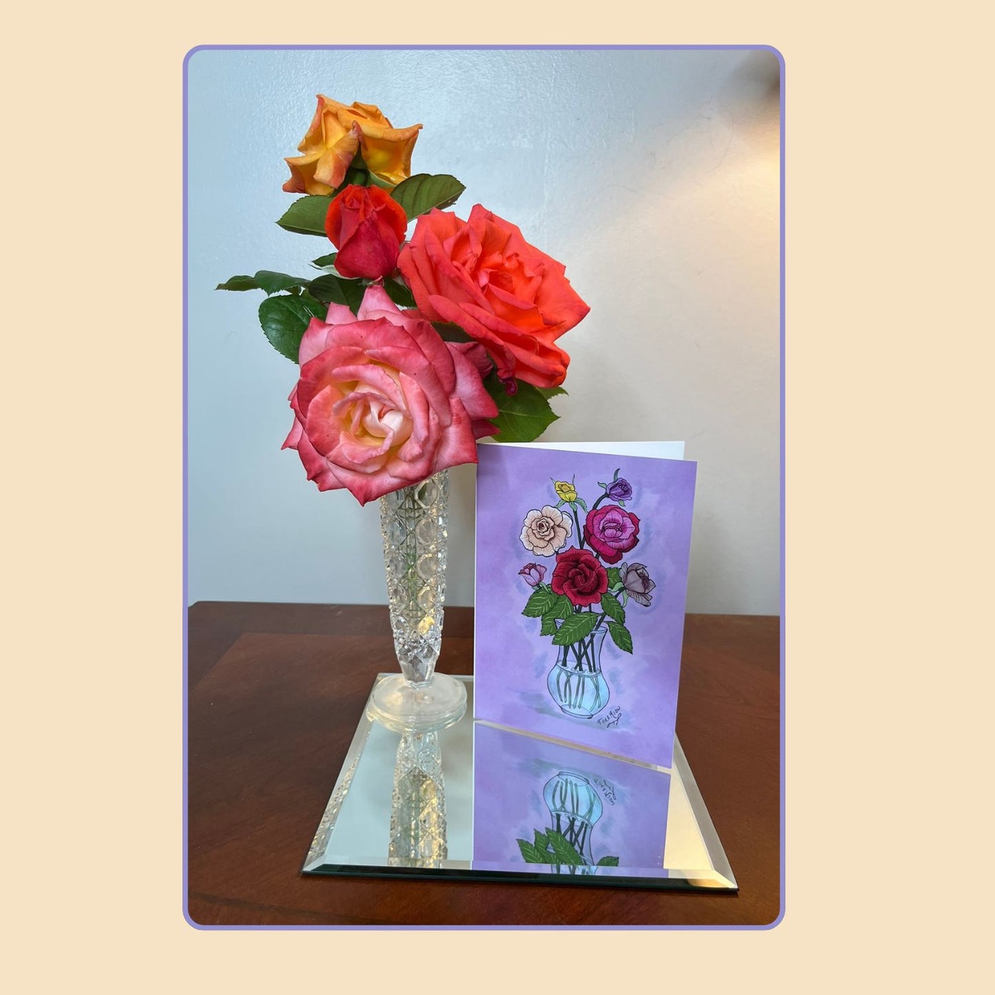 Roses note card from the Blooming Expressions set by Tora Moon, displayed beside a vase of pink and orange roses and a lamp. A graceful lifestyle photo highlighting the romantic floral art design.